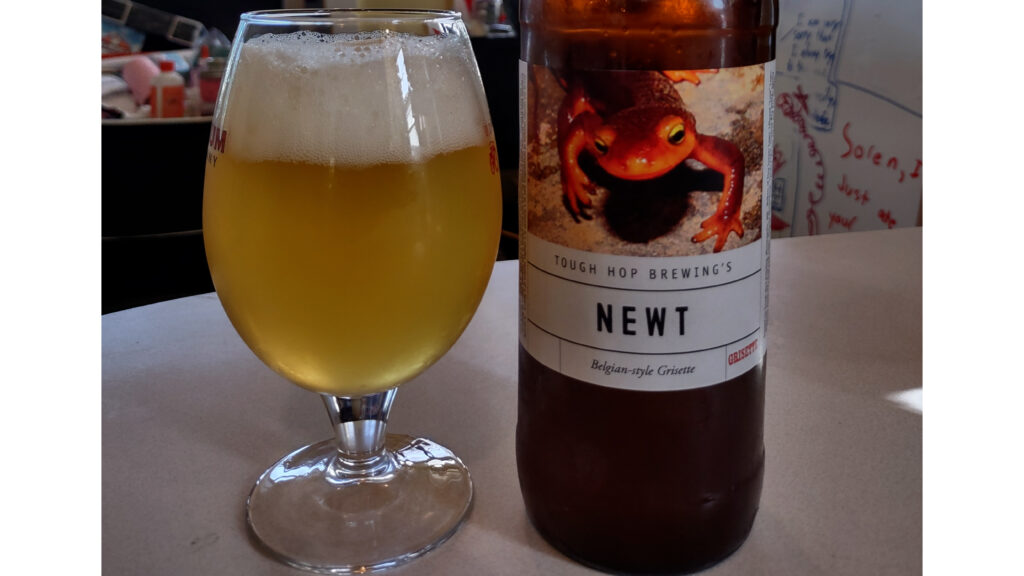 glass of grisette beer with bottle label "Newt"