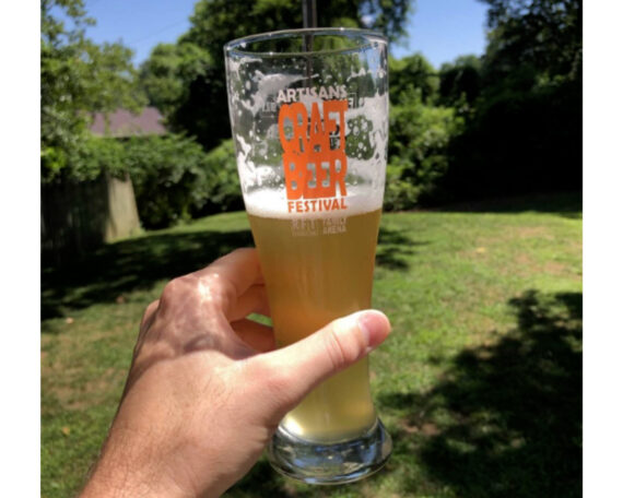glass of piwo grodziskie beer in sunny backyard